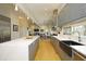 Spacious kitchen showcasing gray cabinets, a large island, and an open layout to living areas at 196 Paces Mill Trl, Pittsboro, NC 27312