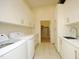 Laundry room with new washer and dryer, white cabinetry, and granite countertops at 196 Paces Mill Trl, Pittsboro, NC 27312