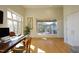 Spacious office area with desk, large windows, and access to an outdoor patio at 196 Paces Mill Trl, Pittsboro, NC 27312