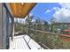 Outdoor patio with overhead wood ceiling, metal railing and lush, leafy trees at 196 Paces Mill Trl, Pittsboro, NC 27312