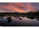 Scenic river view with rock formations and pink sky at sunset, creating a serene and picturesque landscape at 196 Paces Mill Trl, Pittsboro, NC 27312