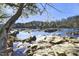 Scenic river view with rocks and trees, sparkling water with leaves falling, great for nature lovers at 196 Paces Mill Trl, Pittsboro, NC 27312