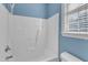 Bathroom with shower/tub combo and blue walls at 215 W Chestnut Ave, Wake Forest, NC 27587