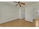 Bedroom with hardwood floors, ceiling fan, and access to closet and bath at 215 W Chestnut Ave, Wake Forest, NC 27587