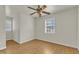 Bright bedroom with hardwood floors, ceiling fan, and ample closet space at 215 W Chestnut Ave, Wake Forest, NC 27587