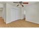 Spacious bedroom featuring hardwood floors, a double door closet, and ceiling fan at 215 W Chestnut Ave, Wake Forest, NC 27587