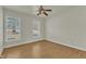 Spacious bedroom with hardwood floors, ceiling fan, and large windows at 215 W Chestnut Ave, Wake Forest, NC 27587