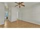 Bedroom with hardwood floors, ceiling fan, and bathroom access at 215 W Chestnut Ave, Wake Forest, NC 27587