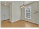 Dining room with hardwood floors, chandelier, and kitchen view at 215 W Chestnut Ave, Wake Forest, NC 27587
