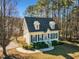 Cute yellow house with blue shutters, gray roof, and landscaped yard at 215 W Chestnut Ave, Wake Forest, NC 27587