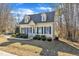 Cute yellow house with blue shutters and landscaping at 215 W Chestnut Ave, Wake Forest, NC 27587