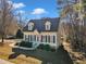 Nice yellow house with blue shutters, gray roof, and landscaped yard at 215 W Chestnut Ave, Wake Forest, NC 27587