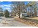 House exterior showcasing a gravel driveway and side yard at 215 W Chestnut Ave, Wake Forest, NC 27587