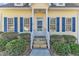 Front entrance with white columns and blue shutters at 215 W Chestnut Ave, Wake Forest, NC 27587