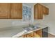 Kitchen sink and countertop with wood cabinets and window at 215 W Chestnut Ave, Wake Forest, NC 27587