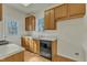 Kitchen features wood cabinets, black appliances, and a back door at 215 W Chestnut Ave, Wake Forest, NC 27587