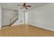 Living room with hardwood floors, stairs, and ceiling fan at 215 W Chestnut Ave, Wake Forest, NC 27587