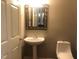 Simple half bathroom with pedestal sink and toilet at 223 Shalimar Dr, Durham, NC 27713