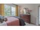 Bright bedroom with double bed, dresser, and yellow curtains at 2255 Horton Park Dr, Apex, NC 27539