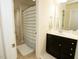 Well-lit bathroom with vanity and a shower featuring a stylish blue and white striped curtain at 248 Begen St, Morrisville, NC 27560