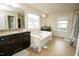 A bathroom featuring a large soaking tub, double vanities, and tile floors at 248 Begen St, Morrisville, NC 27560