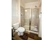 Bathroom with tile shower, glass enclosure, and toilet at 248 Begen St, Morrisville, NC 27560