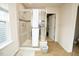 A tiled shower sits beside an open walk-in closet in this bathroom at 248 Begen St, Morrisville, NC 27560