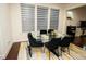 Dining area with a glass table, seating for six, and modern window blinds at 248 Begen St, Morrisville, NC 27560