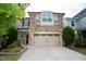 Two-story home with stone and siding exterior, two-car garage, and landscaping at 248 Begen St, Morrisville, NC 27560