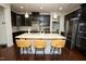 Kitchen featuring a large center island with seating, stainless steel appliances, and dark cabinetry at 248 Begen St, Morrisville, NC 27560