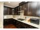 Kitchen featuring a gas range, granite counters, tile backsplash, and dark cabinetry at 248 Begen St, Morrisville, NC 27560