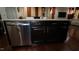 Kitchen island boasts granite counters, dark cabinetry and stainless steel dishwasher at 248 Begen St, Morrisville, NC 27560