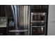 Modern kitchen features stainless steel Samsung refrigerator and built-in microwave and oven at 248 Begen St, Morrisville, NC 27560