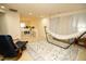 Well lit carpeted living room with hammock and reading chair at 248 Begen St, Morrisville, NC 27560