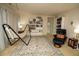 Carpeted living room with hammock, bookshelves, and reading chair at 248 Begen St, Morrisville, NC 27560