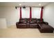 Spacious living room featuring a large leather couch, projector and big screen at 248 Begen St, Morrisville, NC 27560