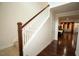 Staircase with hardwood floors and railing, leading to an open floor plan at 248 Begen St, Morrisville, NC 27560