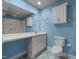 Bathroom with vanity, toilet and shower, light blue walls at 2719 Gordon St, Raleigh, NC 27608