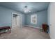 Blue bedroom with ceiling fan and window with shutters at 2719 Gordon St, Raleigh, NC 27608