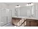 Bathroom vanity featuring dual sinks, modern fixtures, and a large mirror at 277 Chesapeake Commons St # 94, Garner, NC 27529