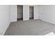 Bedroom with gray walls and carpet, featuring walk-in closets and ample space at 277 Chesapeake Commons St # 94, Garner, NC 27529
