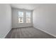 Bedroom with plush carpet, neutral walls, and large windows for plenty of natural light at 277 Chesapeake Commons St # 94, Garner, NC 27529