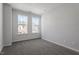 Bedroom with plush carpet, neutral walls, and large windows for plenty of natural light at 277 Chesapeake Commons St # 94, Garner, NC 27529