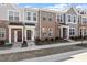 Charming brick townhomes featuring welcoming front porches and well-maintained landscaping at 277 Chesapeake Commons St # 94, Garner, NC 27529
