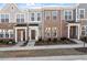 Charming brick townhomes featuring welcoming front porches and well-maintained landscaping at 277 Chesapeake Commons St # 94, Garner, NC 27529