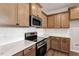 Close-up of kitchen with stainless appliances, countertops, and wooden cabinets at 277 Chesapeake Commons St # 94, Garner, NC 27529