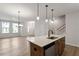 Kitchen island with stainless steel dishwasher, wooden cabinets, and pendant lights at 277 Chesapeake Commons St # 94, Garner, NC 27529