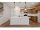 New kitchen features a large island, stainless appliances, wooden cabinets and subway backsplash at 277 Chesapeake Commons St # 94, Garner, NC 27529