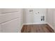 Laundry room with wood-look flooring, utility connections, and fresh white walls at 277 Chesapeake Commons St # 94, Garner, NC 27529