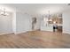 Open-concept living space showcases hardwood floors, stairs, and a kitchen with a breakfast bar at 277 Chesapeake Commons St # 94, Garner, NC 27529